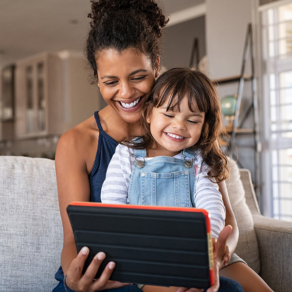 mom and daughter playing on tablet