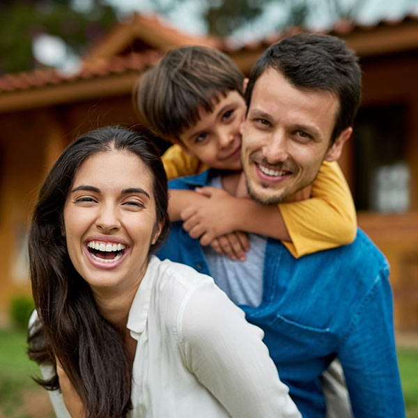 family smiling playing outside