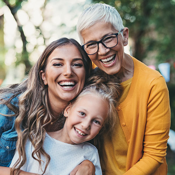 family of 3 smiling
